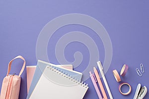 Back to school concept. Top view photo of notebooks pens adhesive tape stapler clips and pink pencil-case on isolated lilac