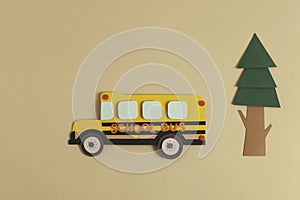 Back to school concept. Yellow bus with tree. Paper cutout artwork.