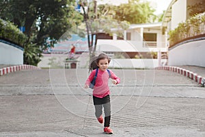 Back to school concept, Young asian cute kid or pupil running into school at morning, Selective focus