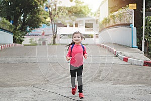 Back to school concept, Young asian cute kid or pupil running into school at morning, Selective focus