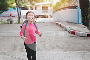 Back to school concept, Young asian cute kid or pupil running into school at morning, Selective focus