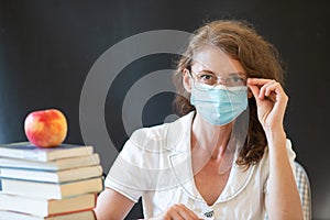 back to school during covid pandemics teacher with face mask