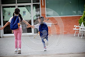 Back to school. Cute Asian child girl with a backpack running and going to school with fun