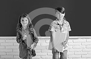 Back to school. Cute little children girl and boy studying in classroom at elementary school.