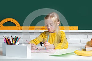 Back to school. Cute pupil girl drawing at the desk. Genius child, knowledge day. Kids education and knowledge. Child in