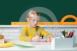 Back to school. Cute pupil girl drawing at the desk. Genius child, knowledge day. Kids education and knowledge. Child in