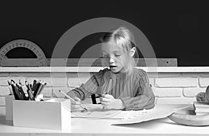 Back to school. Cute pupil girl drawing at the desk. Genius child, knowledge day. Kids education and knowledge. Child in