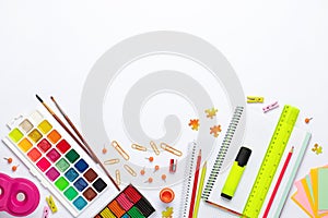 Back to school. Different stationery on white table background, flat lay. Space for text. Top view. Colorful supplies, blank paper