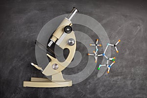 Back To School and education Concept. Alarm clock, microscope and over supplies on blackboard background. Copy Space, top view