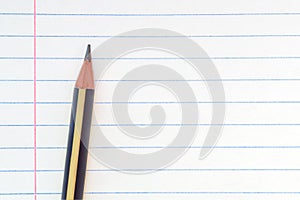 Back to school, education concept - close-up striped pencil on notebook lined paper background for educational new academic year