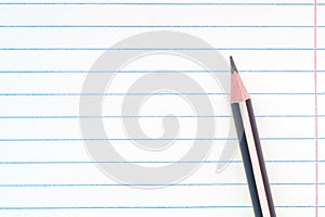 Back to school, education concept - close-up striped pencil on notebook lined paper background for educational new academic year