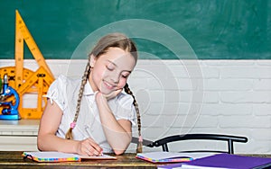 Back to school on first of september. Hooked on learning. Accelerating into future. Girl cute child sit school classroom