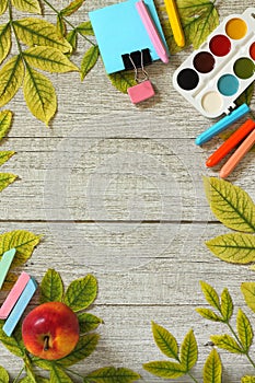 Back to school. Flatlay background. Table with autumn leaves and different school supplies, stationery, pencils.
