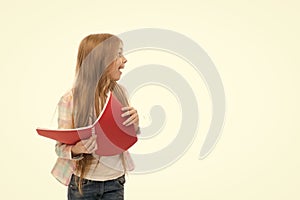 Back to school goods. Cute little girl holding school exercise book. Adorable small school child with open note book