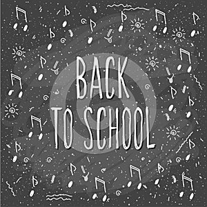 Back to school. Hand drawn lettering and doodle chalk music elements on classroom chalkboard