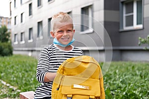 Back to school. Happy Boy wearing mask and backpacks protect and safety from coronavirus. Child going school after