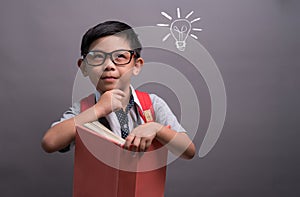 Back to school, Happy child little boy with glasses reading a books, Concept of education and reading.