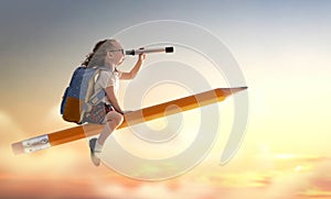 Child flying on a pencil photo