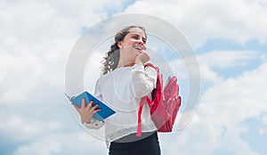Back to school. Happy girl with school backpack sky background. Little child going to school. Knowledge day. Outdoors