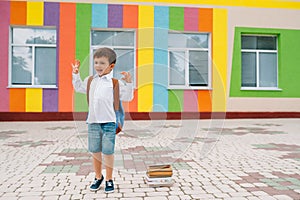 Back to school. Happy smiling boy in glasses is going to school for the first time. Child with backpack and book