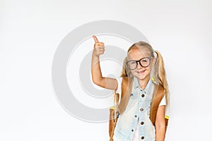 Back to school and happy time. Cute child with blonde hair on white background. Kid with backpack. Girl ready to study. Mockup,