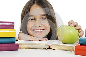 Back to school and happy time! Cute industrious child is sitting at a desk Girl reading the book