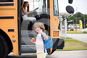 Back to school and happy time. Education: Smiling Elementary Student Ready To Board Bus.