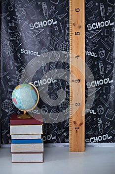 Back to school. Interior of elementary school. Chalkboard, Books, globe and stationery on classroom. Teachers Day concept. Empty c
