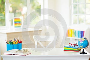 Back to school. Kids desk with books, globe