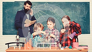 Back to school. kids in lab coat learning chemistry in school laboratory. chemistry lab. making experiment in lab or