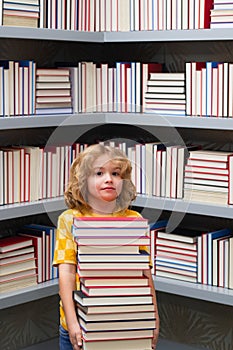 Back to school. Little student on school library. Kid reading book at school. Nerd pupil. Clever intelligent schoolboy