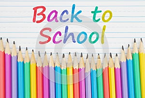 Back to School message with color pencils on vintage ruled line notebook paper