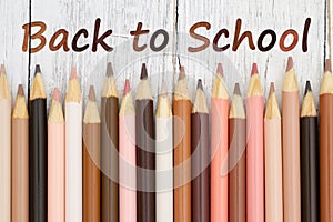 Back to school message with multiculture skin tone color pencils photo