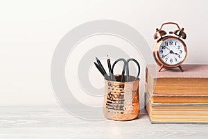 Back to school modern background with books, alarm clock