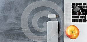 Back to school modern technology objects on erased chalkboard