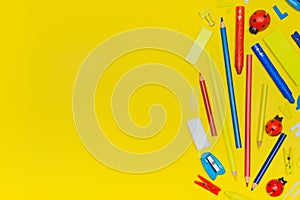 Back to school and office work concept. School supplies on yellow color background.