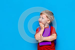 Back to school Portrait of happy surprised kid in glasses isolated on blue background with copy space. new school knowledges