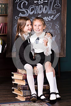 Back to school. Portrait of two girls, first graders.