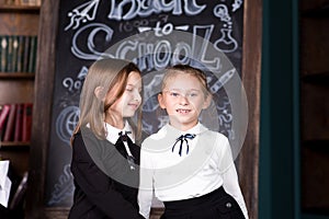 Back to school. Portrait of two girls, first graders.