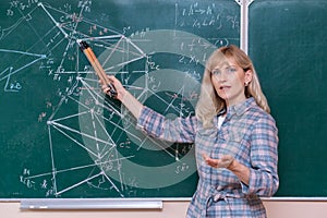 Back to school. The professor solves the problem at the blackboard