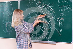 Back to school. The professor solves the problem at the blackboard