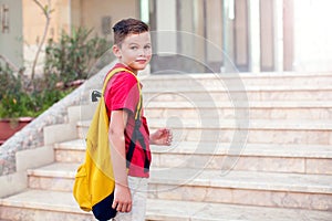 Back to school. Pupil boy with backpack going to school