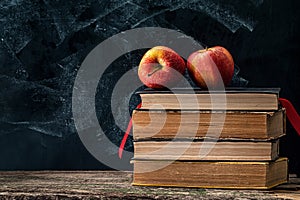 Back to school, Red Apple fruits on top of Book on Stack of Books with chalk board