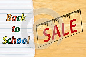 Back to School sale on lined paper on a desk