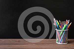 Back to school. School supplies on black board background. Education concept