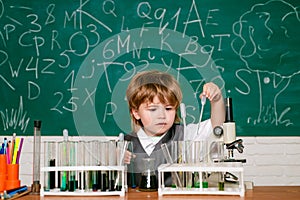 Back to school. Science and education concept. Learning at home. Kid is learning in class on background of blackboard