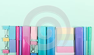 Back to school shopping concept. Pastel colored school supplies on paper background. Flat lay, top view, copy space.