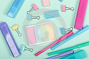 Back to school shopping concept. Pastel colored school supplies on paper background. Flat lay, top view, copy space.