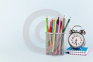 Back to school shopping concept. School supplies on blue background. Flat lay, top view, copy space.