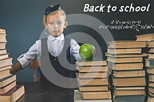 Back to school. Smart school girl reading book at library